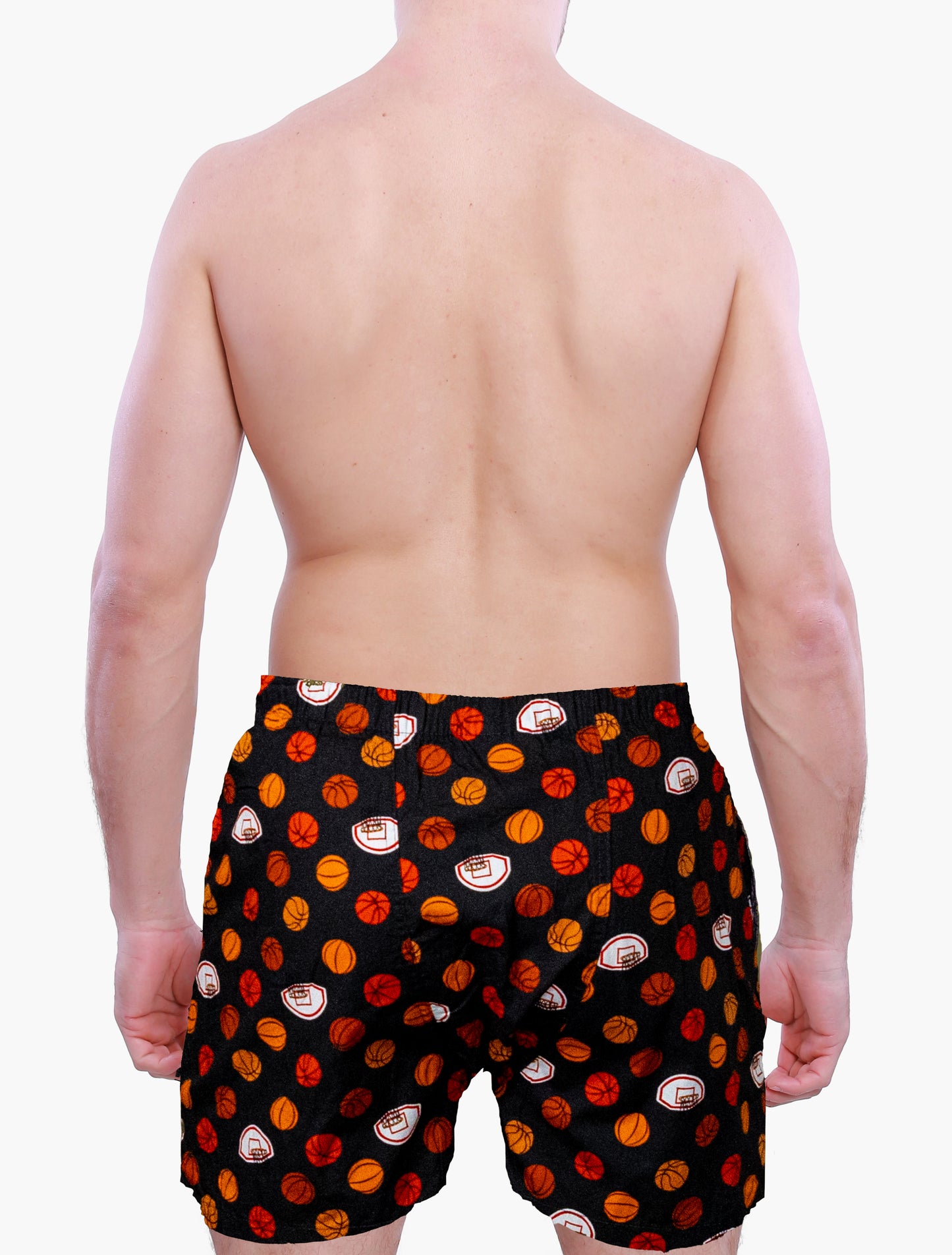 Back side of a Person wearing black swim shorts with red and orange basketball graphics on a white background