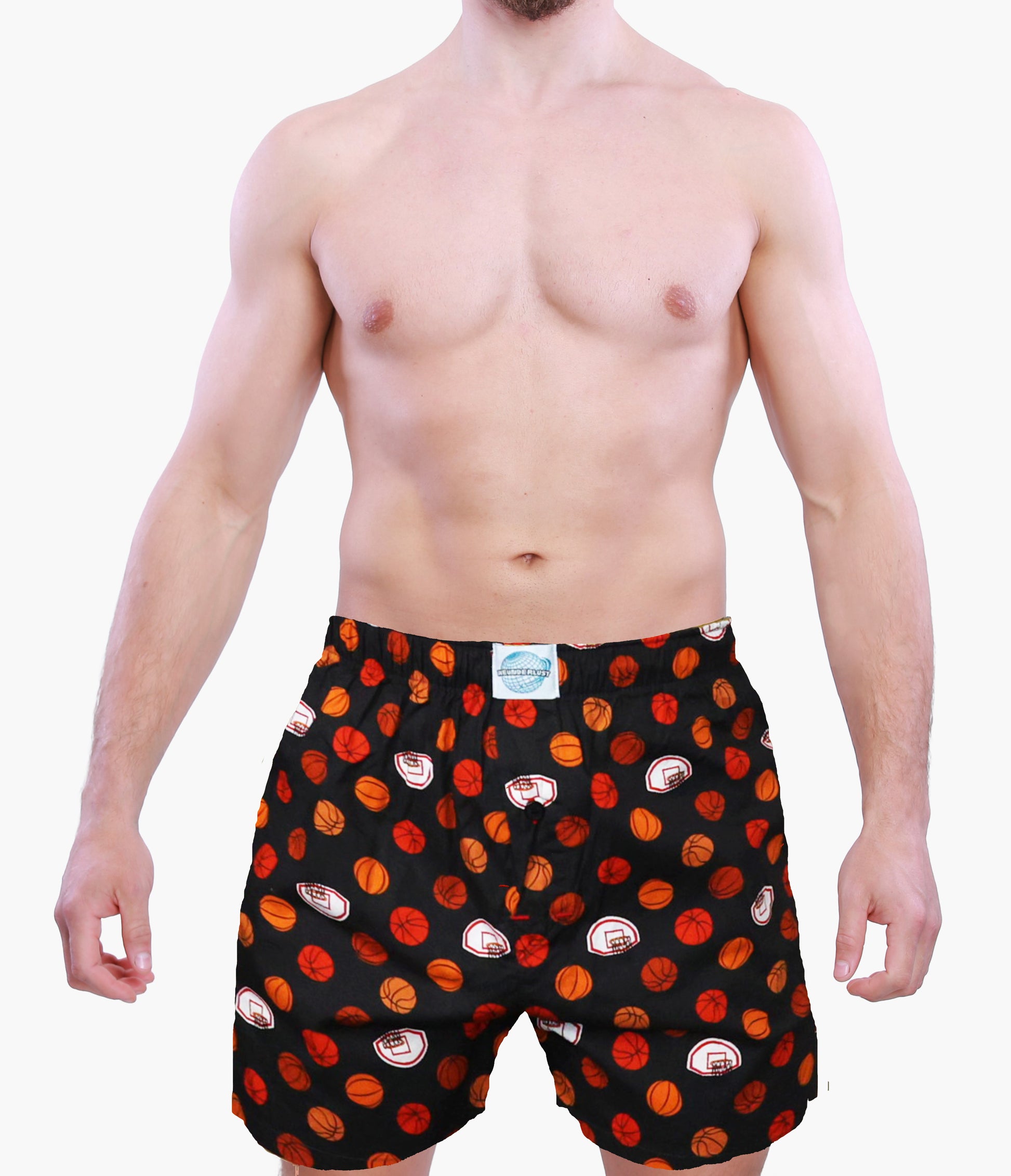 Man wearing black boxer shorts with red and orange basketball graphics on a white background