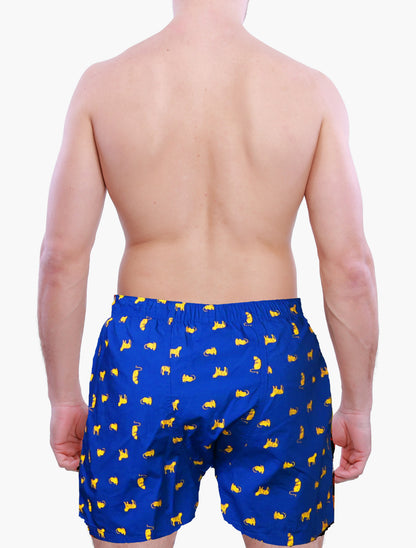 Back side of a male model wearing Blue boxer shorts with yellow cats graphics on a white background