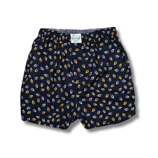 Navy shorts with yellow and white leaf pattern on a white background