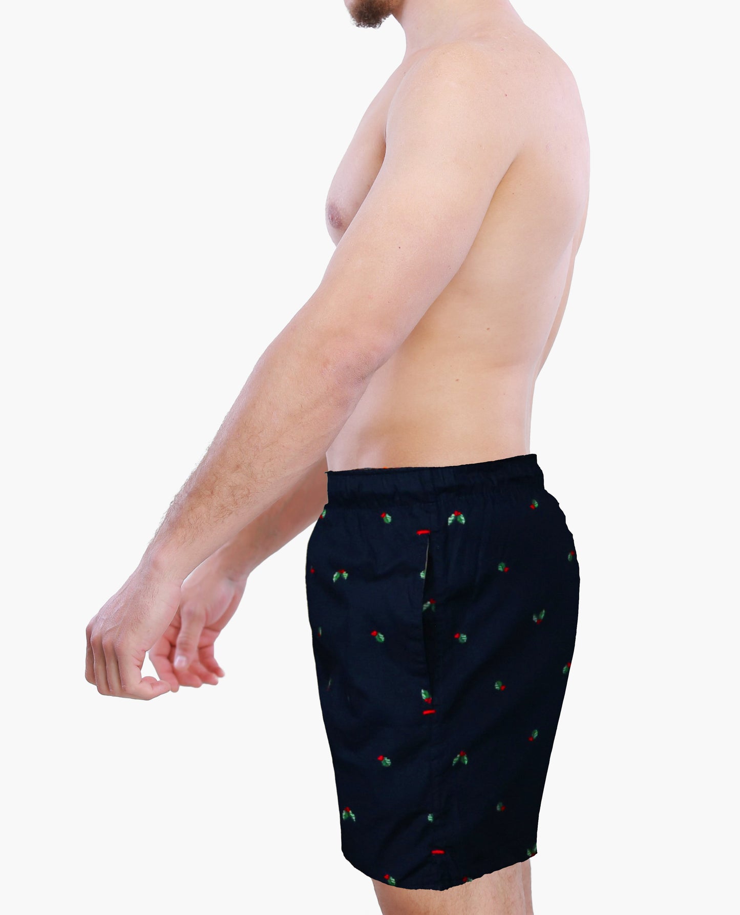 Side view  of a male model wearing Weunderlust navy boxer shorts briefs with hollies graphics on a white background
