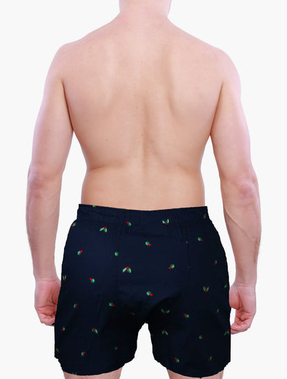 Person wearing Weunderlust navy boxer shorts briefs with hollies graphics on a white background