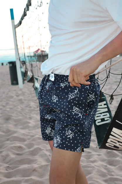 Male Model in Weunderlust Woven Cotton Boxers with pockets at the beach, into the night, Navy, stars printing