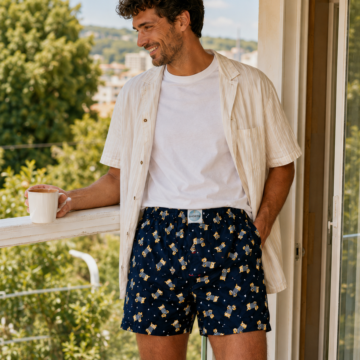Man wearing Weunderlust navy boxer shorts with dog pattern on a balcony