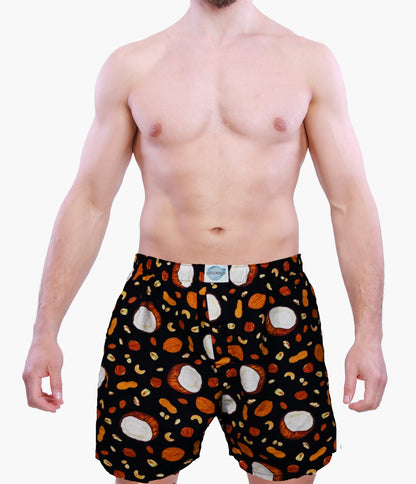 Man wearing Weunderlust boxer Shorts with a pattern of coconut and nuts on a white background