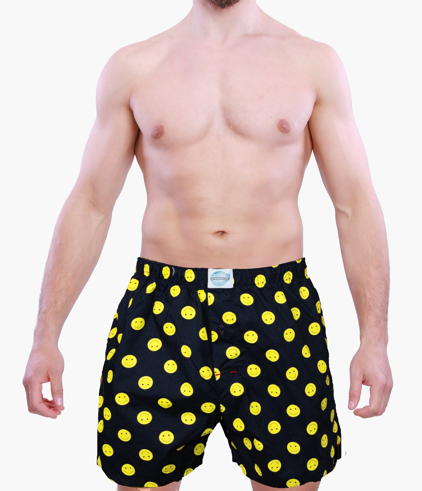 Man wearing black boxer shorts with yellow smiley icons on a white background