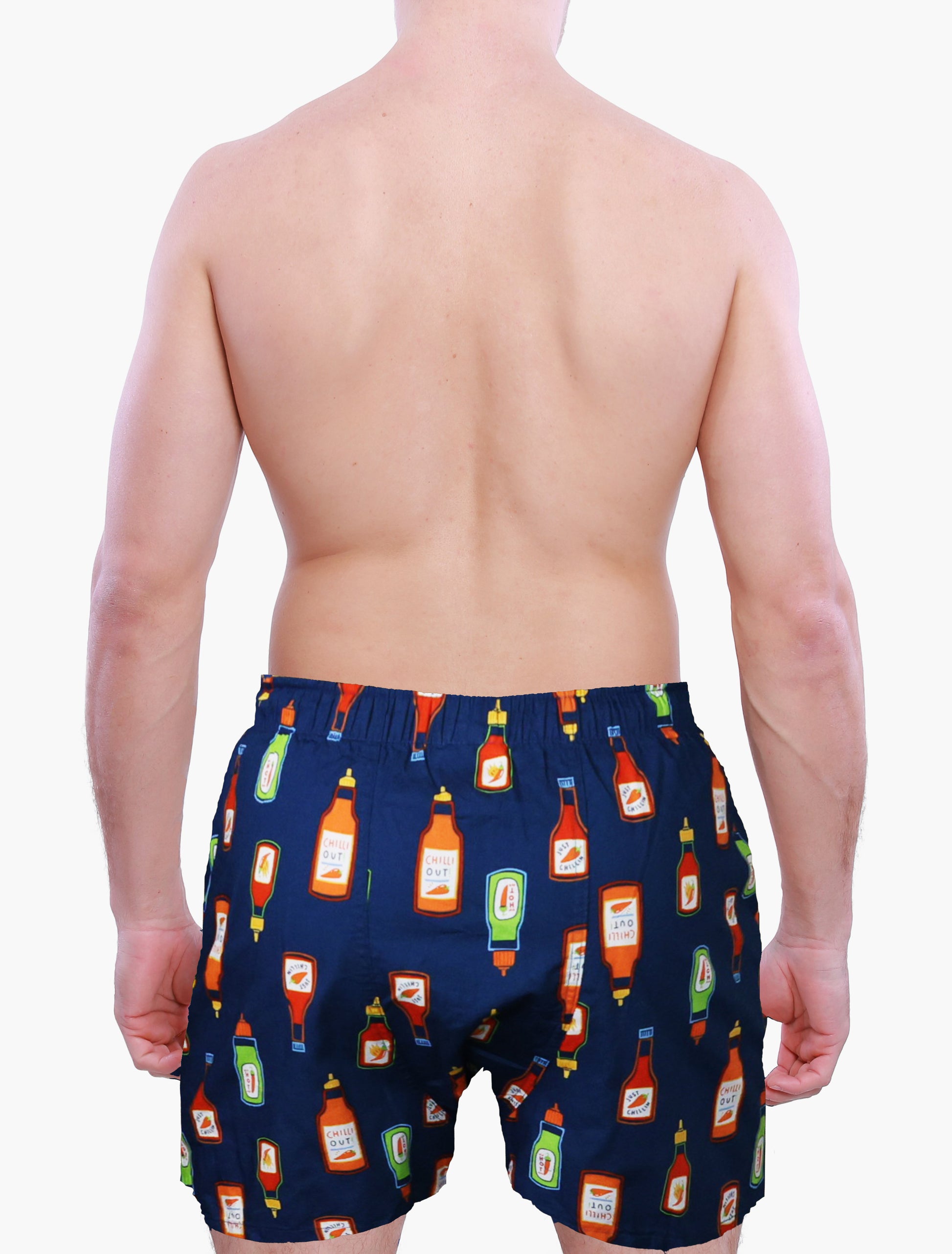 back side of a male model wearing Weunderlust Navy blue boxer shorts  with hot sauce bottle pattern on a white background
